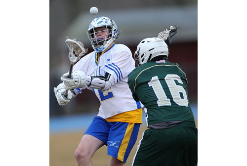 Mattituck/Greenport/Southold's Tyler Seifert puts a shot on goal despite the efforts of Bishop McGann-Mercy's Andrew Glasgow. (Credit: Garret Meade)