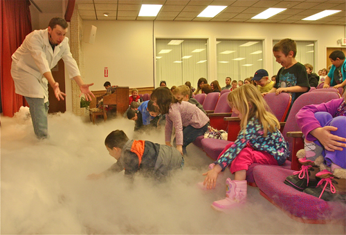 BARBARAELLEN KOCH PHOTO | Mad Scientist professor Will Hill fills the auditorium with CO2 gas 'fog' by dropping dry ice into buckets of hot water.