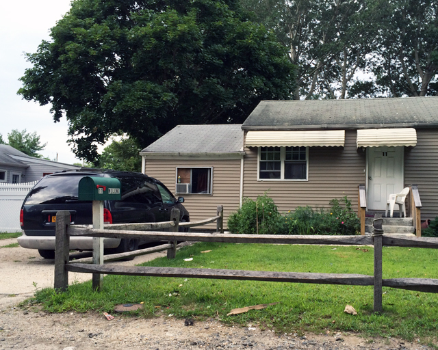 A Riverhead man was killed when he got pinned underneath his truck at 11 Melene Avenue Saturday.(Credit: Grant Parpan)