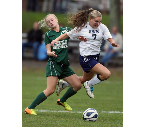 Shoreham-Wading River junior Megan Kelly fights for the ball with Lauren McMahon of Harborfields. (Credit: Daniel De Mato)