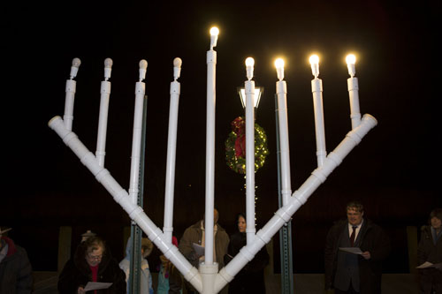 KATHARINE SCHROEDER PHOTO | Members of Temple Israel celebrate the menorah lighting at the Peconic Riverfront.