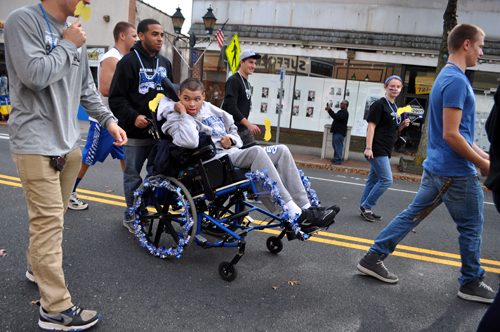 RACHEL YOUNG PHOTO | Michael Hubbard, seated, led the Class of 2014's float at the Riverhead homecoming parade Saturday.