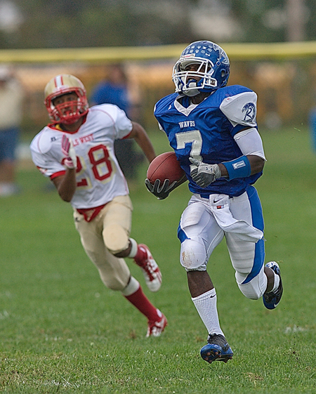 Moore GARRET MEADE PHOTO | Riverhead wide receiver Reggie Moore scored on an 82-yard pass play on the Blue Waves' first play from scrimmage.