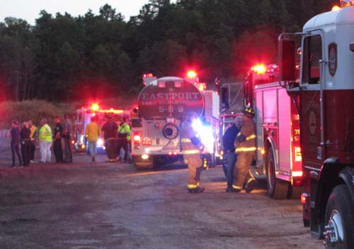 TIM GANNON PHOTO | Firefighters extinguish a mulch fire in Calverton Thursday evening.
