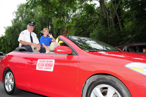 Fifty-year-member of the Jamesport Fire Department Daniel Griffin gets escorted on Wednesday night.