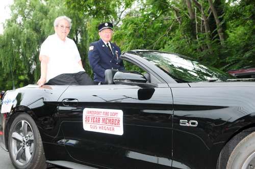 Fifty-year-member of the Jamesport Fire Department Gus Hegner gets escorted on Wednesday night.