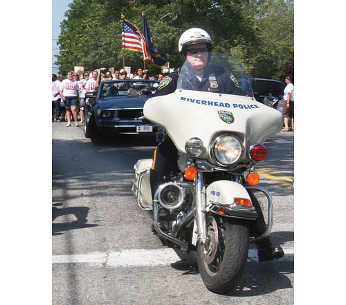 BARBARAELLEN KOCH FILE PHOTO | Riverhead Police Officer Dennis Cavanagh helps lead the annual 'Say No to Drugs' March with Pulaski Street students in 2012.