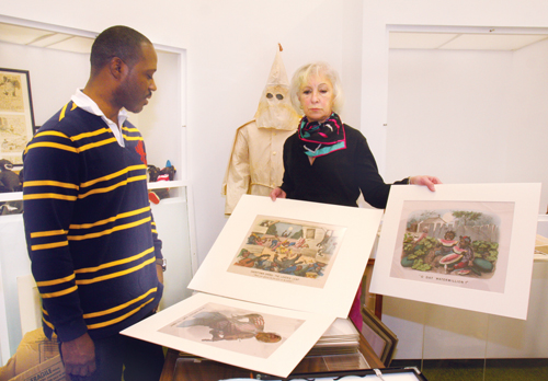 BARBARAELLEN KOCH PHOTOCurator David Byer-Tyre and SCHS executive director Kathy Curran holding Currier and Ives 'Dark Town' series prints.