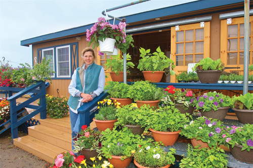 Farmer Debbie Schmitt at her new semi-mobile farmstand that she had built toward the end of 2013 on Sound Avenue in Riverhead. (Credit: BARBARAELLEN KOCH )