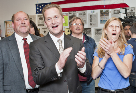 Riverhead Town Councilman Jim Wooten (left), Supervisor Sean Walter and his wife Cathleen cheer the early returns.