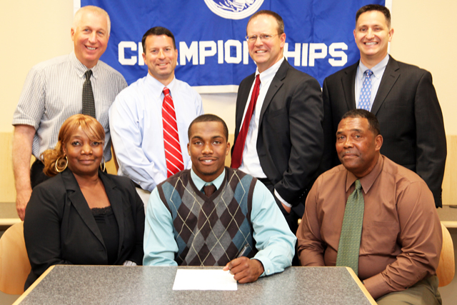 RJ Foster will play football and lacrosse at Dean College. He was joined by his parents Edith and Roger for a signing ceremony as well as athletic director Bill Groth (from left) varsity coach Vic Guadagnino, guidance counselor Chris Martin and assistant principal Sean O'Hara. (Credit: Riverhead School District)
