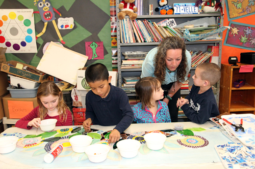 Paige Raynor Giancarlos Velasquez, Genevieve Matwey and Frank Capone work with visiting artiste Clare Bennett on a mosaic for the library.
