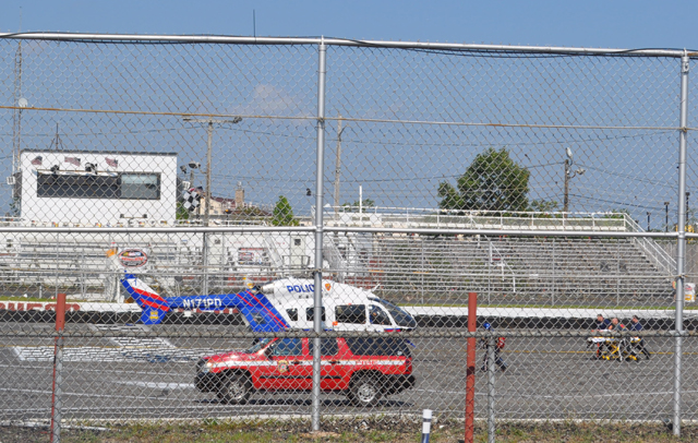 Emergency personnel transport a patient to a police helicopter following a go-kart crash at Riverhead Raceway Sunday. (Credit: Grant Parpan)