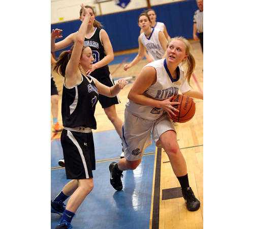 One of Riverhead's three seniors, Cassidy Brown, looks for shooting room while being guarded by Centereach's Alicia Indence. (Credit: Garret Meade)