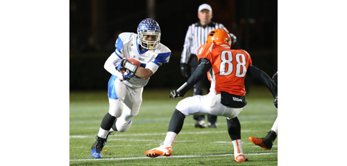 DANIEL DE MATO PHOTO | Riverhead's Jaron Greenidge runs for a first down before meeting up with Carey's Taylor Steinberg.
