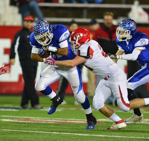 ROBERT O'ROURK PHOTO | Jeremiah Cheatom surges forward, bringing Riverhead yardage against East Islip.