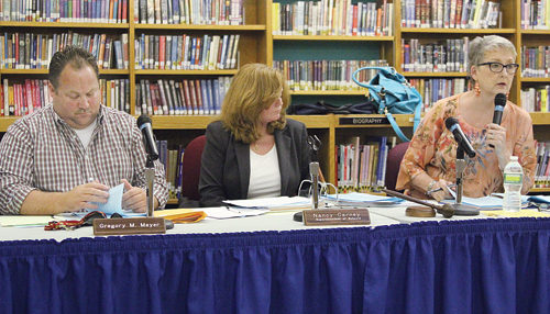 From left, school board vice president Greg Meyer, Superintendent Nancy Carney and board president Ann Cotten-DeGrasse during a public hearing in August, at which Ms. Carney spoke at length about more planned construction work for the high school.
