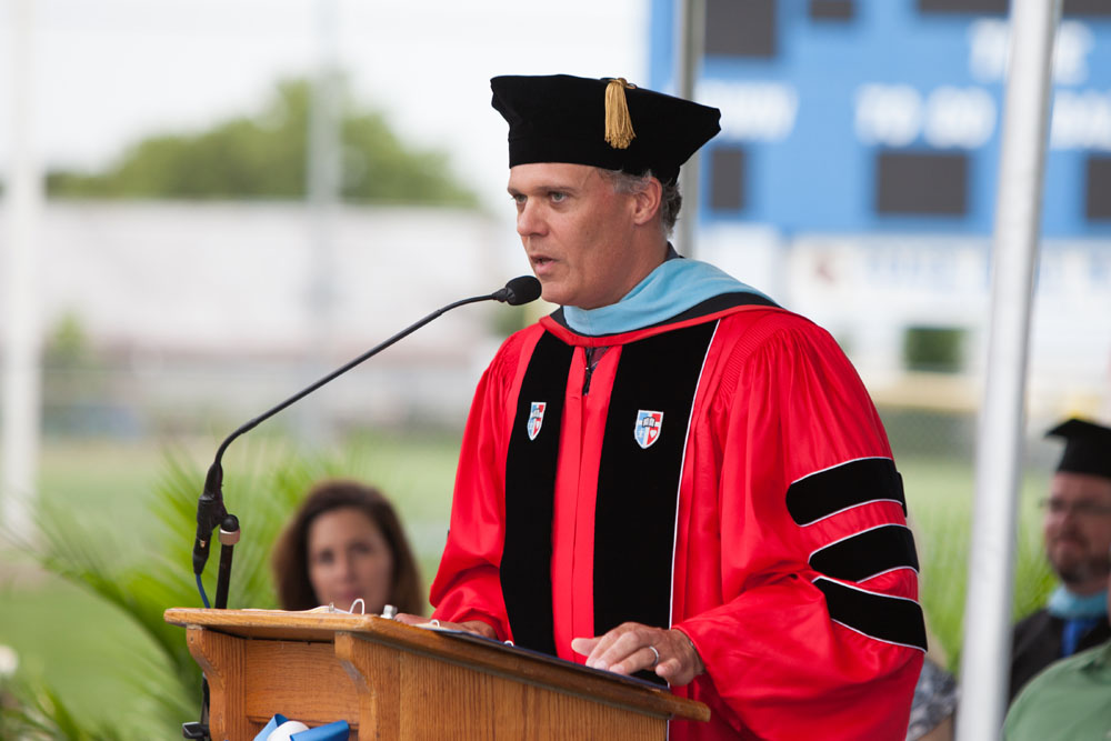 Dr. Charles Regan, High School Principal, welcomes everyone.