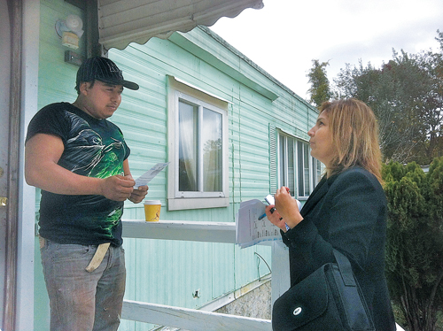 Riverside Rediscovered's Siris Barios talks to Riverside resident Adonis Estrada of Pine Street Friday afternoon. (Credit: Tim Gannon)