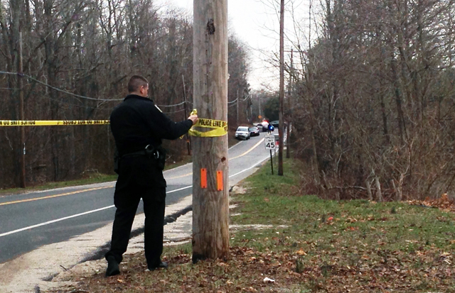 A police officer closes off Sound Avenue during the investigation Sunday afternoon. (Credit: Joe Werkmeister)