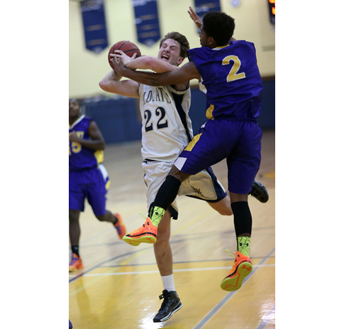 Greenport's Darius Bolling (2) tries to stop Shoreham-Wading River's Dan Hughes, one of three 11-point scorers for the Wildcats. (Credit: Garret Meade)