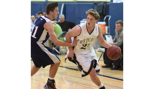 Shoreham-Wading River's Dan Hughes, guarded by Eastport/South Manor's Tristan Lucacci, scored 25 points in his team's home opener. (Credit: Robert O'Rourk)