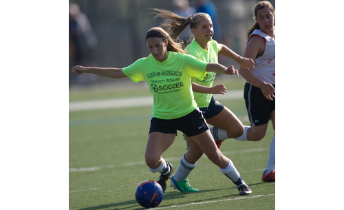 Shoreham-Wading River's Alexandra Kuhnle, on the ball, and Megan Kelly during Thursday's quarterfinal against Center Moriches. (Credit: Garret Meade)