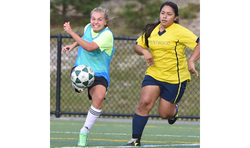 Meg Kelly, who scored one goal and assisted on another for Shoreham-Wading River, boots the ball upfield against Brentwood. (Credit: Robert O'Rourk)