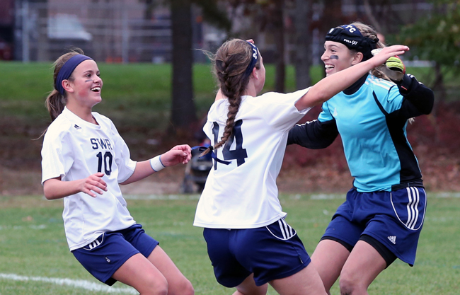 Shoreham-Wading River goalkeeper Lydia Kessel is mobbed by teammates Samantha Higgins (14) and Haley Rose after Friday's win. (Credit: Daniel De Mato)