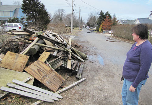 TIM GANNON PHOTO | A giant pile of superstorm Sandy debris has sat in front of Sheila Ganetis' Morningside Avenue home in Jamesport for almost two months. Town officials say she'll need to pay to get the junk removed.