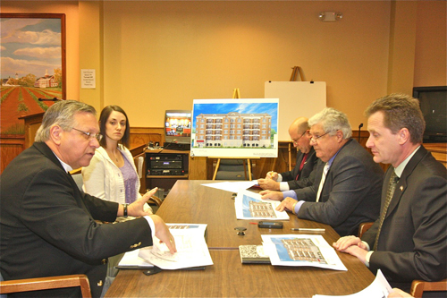 BARBARAELLEN KOCH PHOTO | Architect Martin Sendlewski (left) pitches the apartment building plan to Town Board members Thursday.