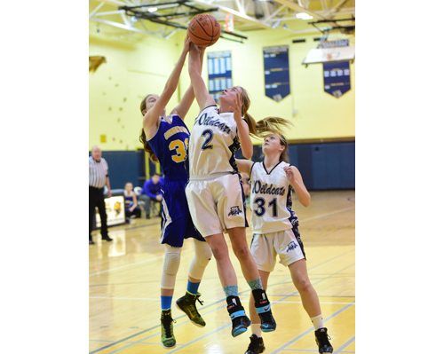 Shoreham-Wading River's Courtney Clasen battles for a rebound with Comsewogue's Sam Collins. Sam Higgins stood nearby. (Credit: Robert O'Rourk)