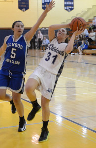 ROBERT O'ROURK PHOTO | Shannon Rosati of Shoreham-Wading River attempting an off-balance shot while Elwood/John Glenn's Mackenzie Sivilli tries to stop her.