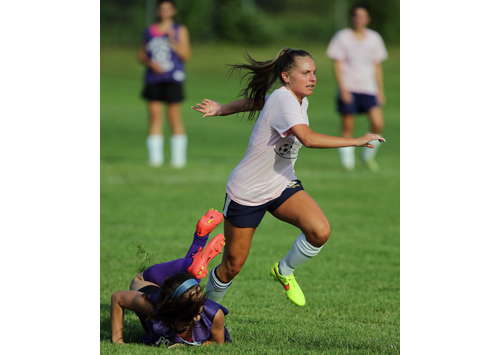 Shoreham-Wading River's Megan Kelly leaves a Port Jefferson defender in her wake as she moves the ball up the field. (Credit: Daniel De Mato)