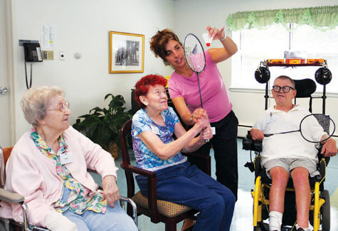San Simeon by the Sound Adult Day Care recreation supervisor Renee Genova assists residents during a game of badminton in 2011. (Credit: Katharine Schroeder, file)