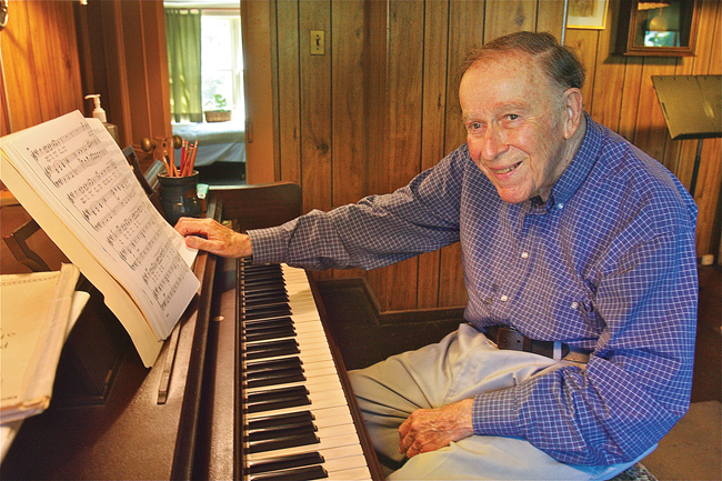 Arthur Swan in his living room in Greenport. At age 89, he'll be leaving his longtime home next week, for a new adventure. (Credit: Barbaraellen Koch)