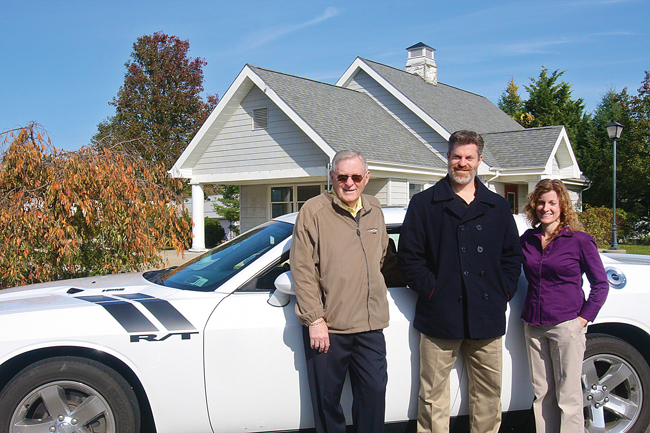 Riverhead Dodge president Tony Strollo (left) with his son T.J. Strollo, vice president, and daughter Jane Millman, secretary and treasurer, at the former Out East Family Fun site on Route 58, which they recently purchased to relocate their dealership. (Credit: Barbaraellen Koch)
