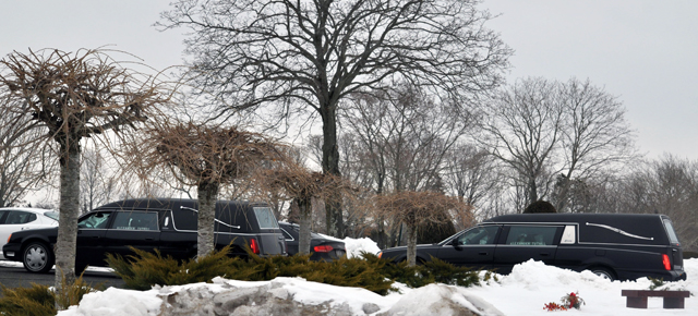 A pair of hearses lead a lenghty funeral procession into Washington Memorial Park in Coram. (Credit: Grant Parpan)