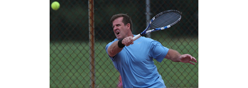 Kieran Corcoran returning a shot Sunday when he and Chris Ujkic won their eighth straight men's doubles title in the Bob Wall Memorial Tournament. (Credit: Garret Meade)