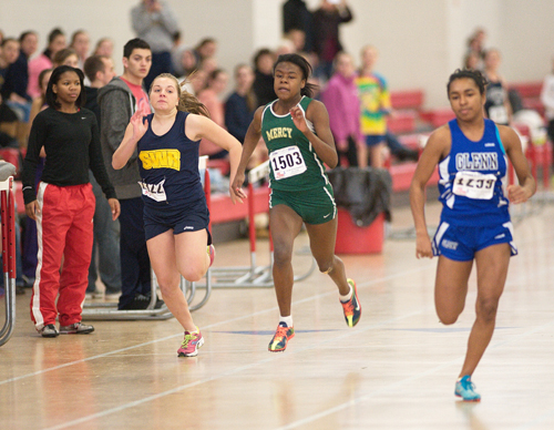 GARRET MEADE PHOTO | McGann-Mercy junior Danisha Carter races in the 55-meter dash alongside Shoreham-Wading River freshman Megan Kelly.