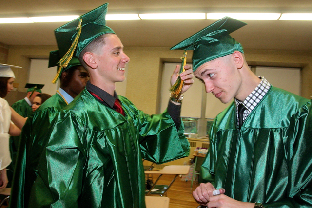 Jules Guasp of Ridge (left) helps his friend Tyler Hamburger by fixing his tassel. (Credit: Barbaraellen Koch)