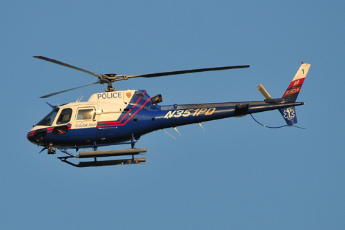 A Suffolk County police helicopter searches for the missing boy Tuesday afternoon above Veterans Memorial Park in Calverton. (Credit: Bill Landon)