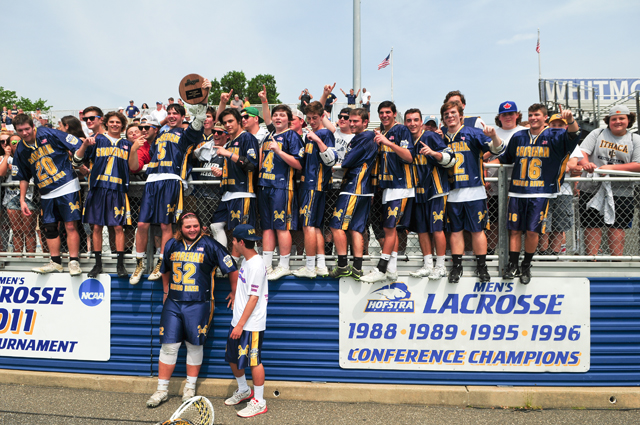 The Wildcats scale the fence following their Long Island Championship win at Hofstra University Saturday afternoon. (Credit: Bill Landon)