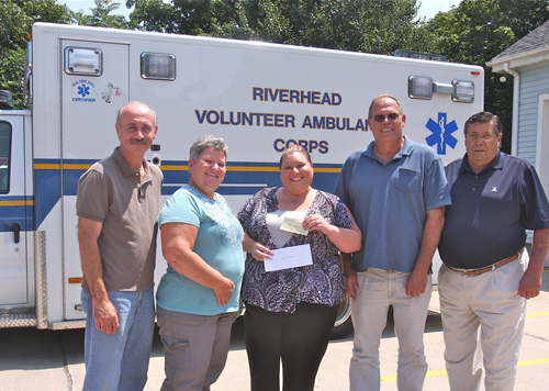 ambulance BARBARELLEN KOCH PHOTO | Riverhead Volunteer Ambulance Corp board president Kim Porkorny (center) and vice president Joe Sokoloski (far left) accepted donation s from 'Heidi's Helping Angels' honoree members (from left) June and John Behr and president Jim Stark Tuesday afternoon.