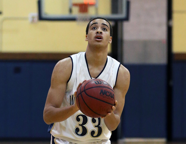 Shoreham-Wading River senior Jonah Caldwell, pictured against Amityville, scored 23 points in the Wildcats' loss to Bayport Tuesday. (Credit: Daniel De Mato)