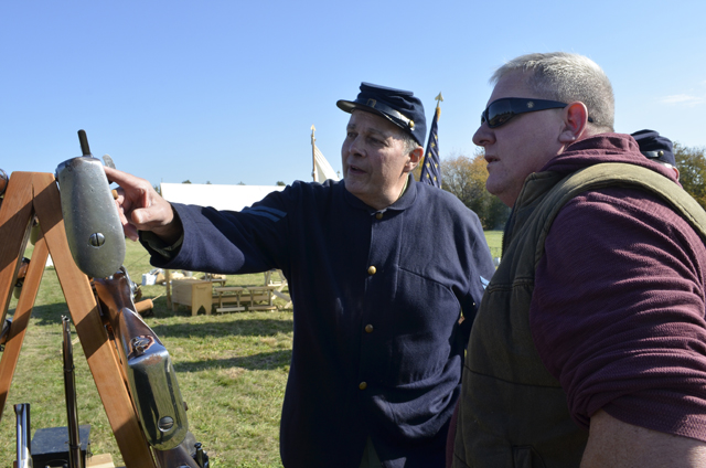 Dave Courtenay of the 67th New York Volunteer Infantry’s Company K talks rifles with Steve Thompson of Baiting Hollow.