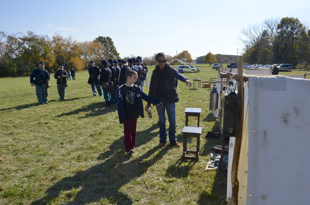 Sean Peterson, 9, and Christine Hogan of Mattituck explore the Civil War encampment.