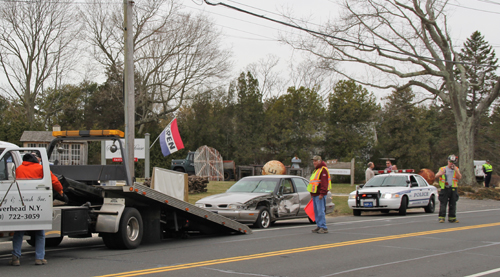 The female driver of a tan Oldsmobile was arrested after swerving into the westbound lane on Main Road in Jamesport. (Credit: Carrie Miller)