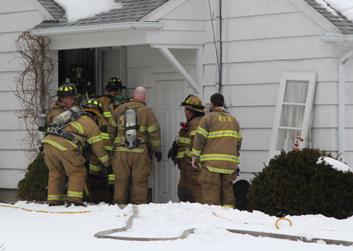 Volunteers at the back door of the Newtown Avenue home. (Carrie Miller Photo)