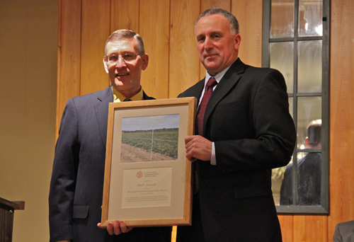 Cornell Cooperative of Suffolk County Agriculture Program director Dale Moyer honoring Mark Zaweski (Credit: Carrie Miller)